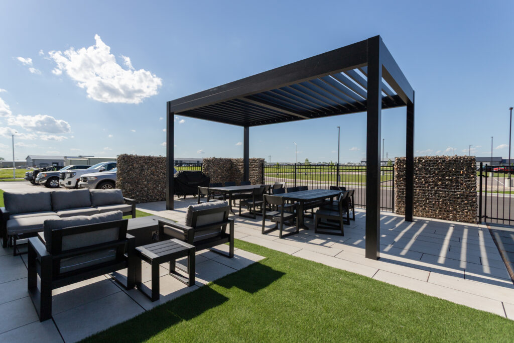 Commercial pergola installation, black fixed louvered pergola
