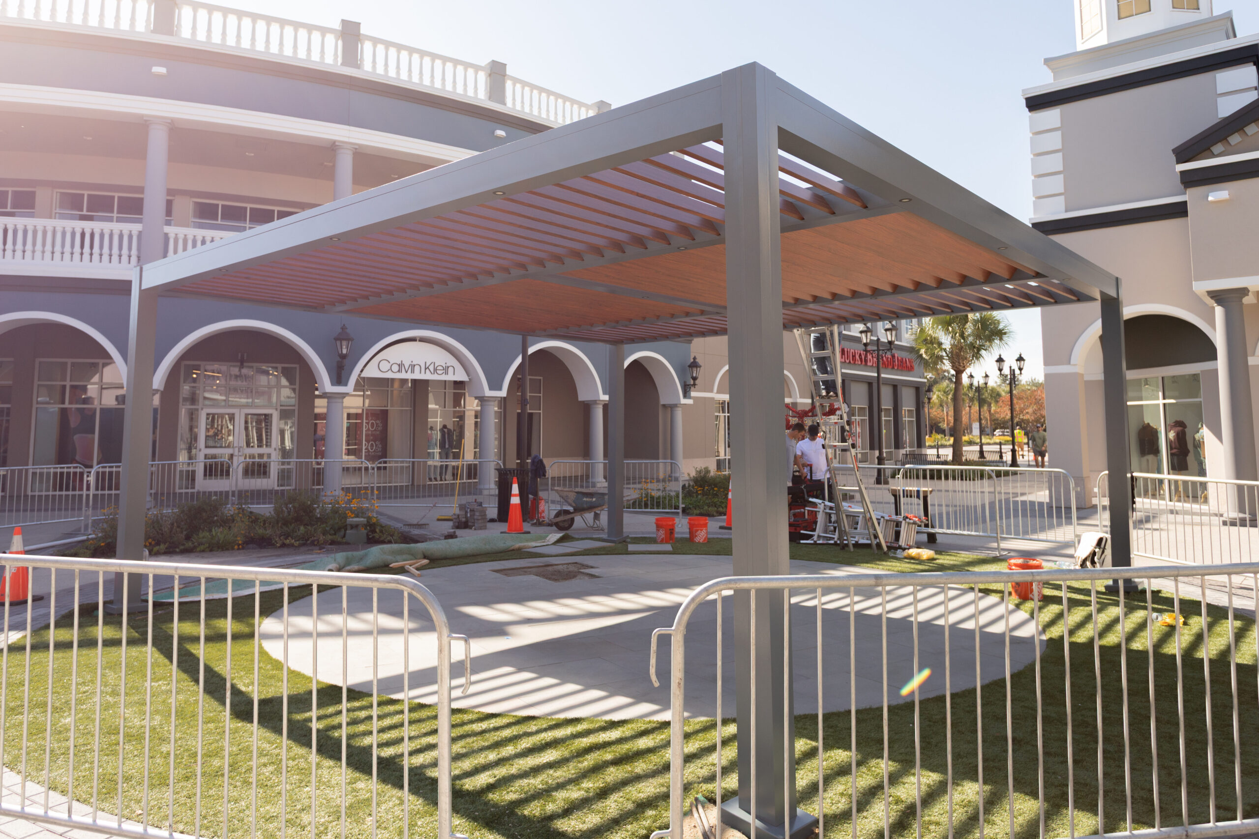 fixed louvered pergola at an outlet mall