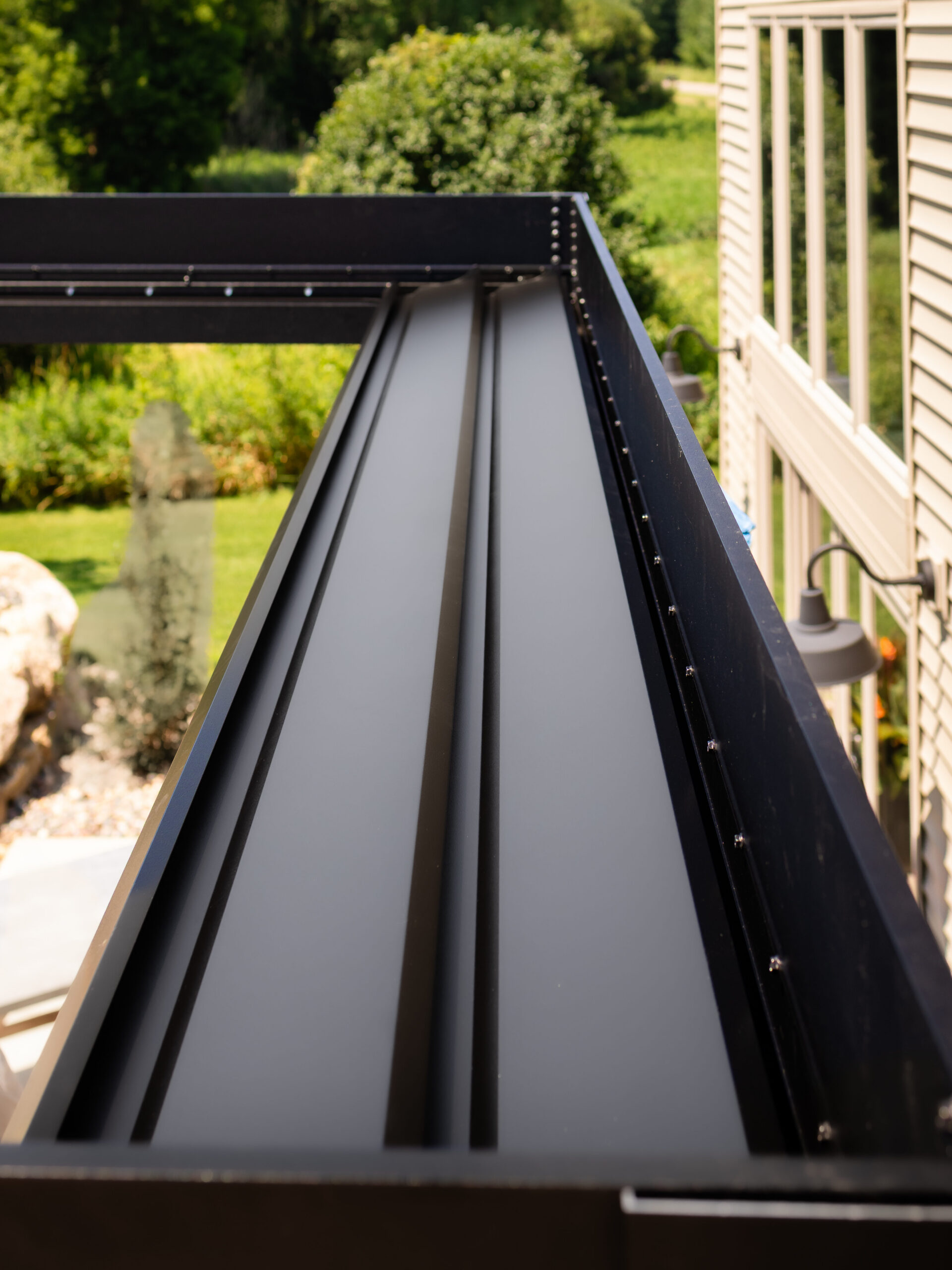 custom pergola with louvers to channel away water
