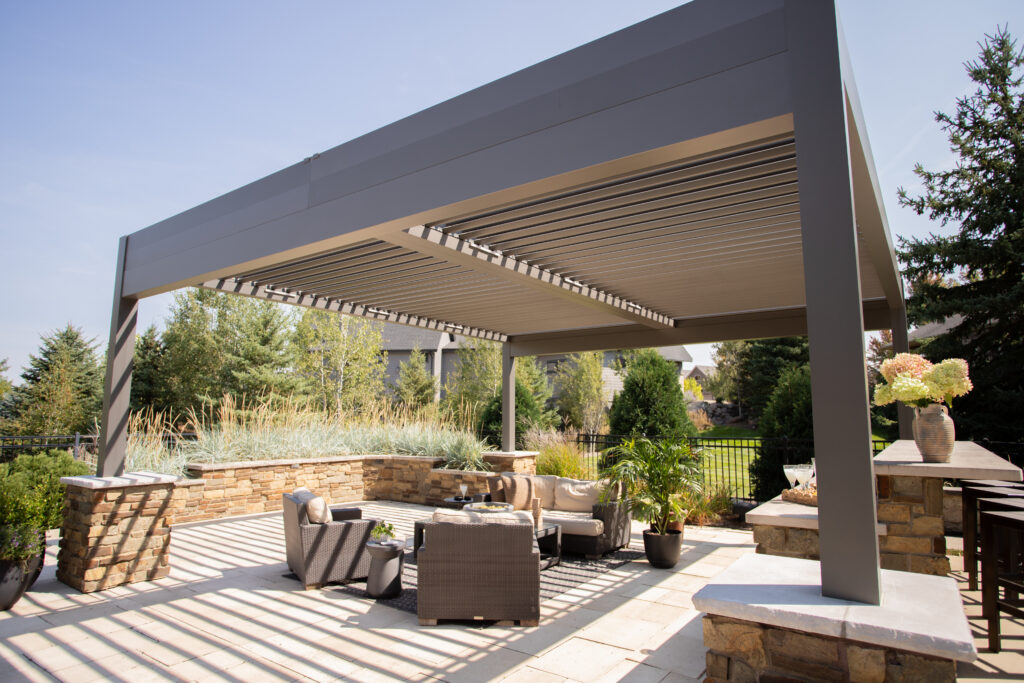 custom aluminum pergola over an outdoor kitchen and seating area