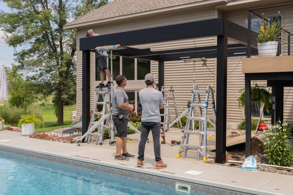 pergola installation process on patio in Elk River Minnesota with custom layout