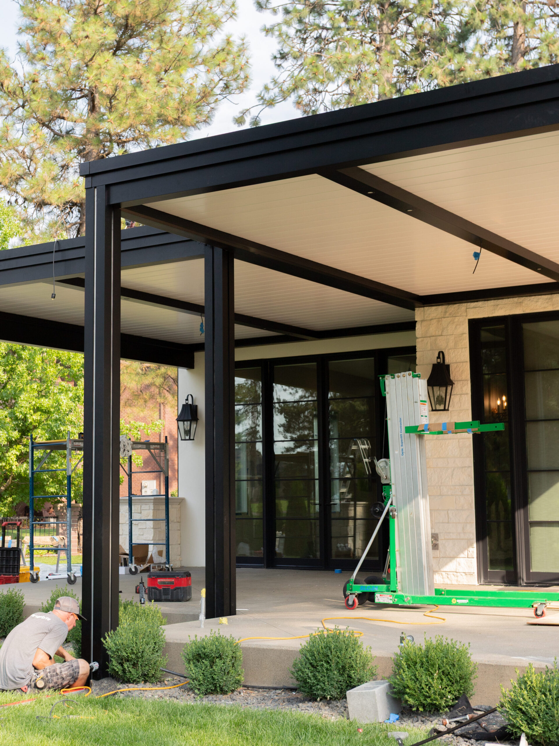 After the posts are set and anchored in place, the louvers are added to the top of the pergola, creating shade and covering the patio below.