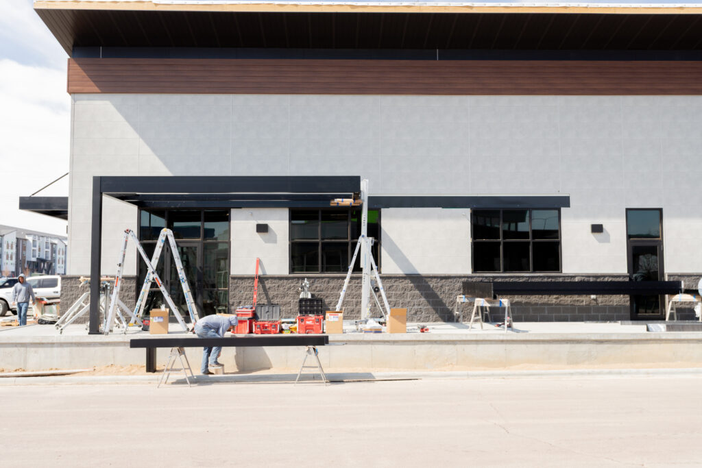 installing an R-SHADE pergola to create shade on a restaurant patio